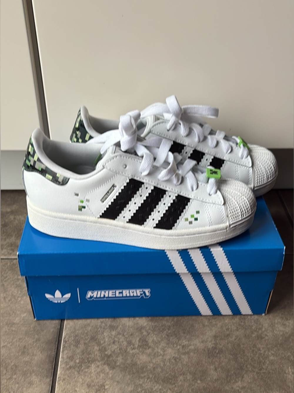 adidas Kids White Sneakers with Black Stripes & Green Pixel Accents